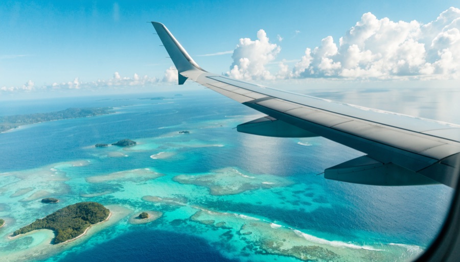 Airplane wing over Philippine islands — AirAsia promo fares guide